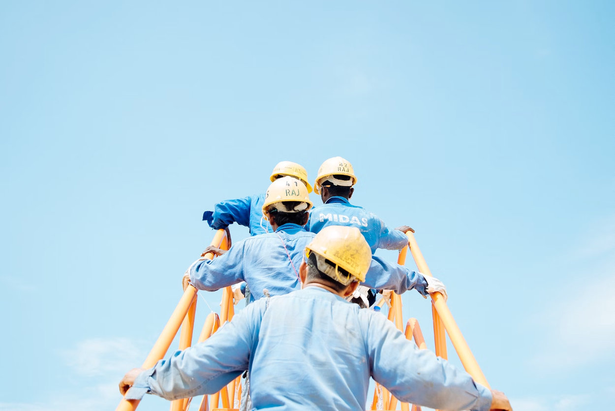 Trabajadores subiendo escalera en la construcción